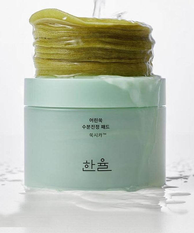 HANYUL Young Mugwort Moisturizing Soohting Pad in green jar with stack of soothing pads; skincare product promotion