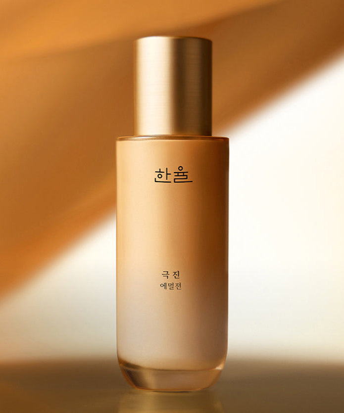 HANYUL Extreme Emulsion 125ml bottle with golden cap and Korean branding on a warm gradient background.