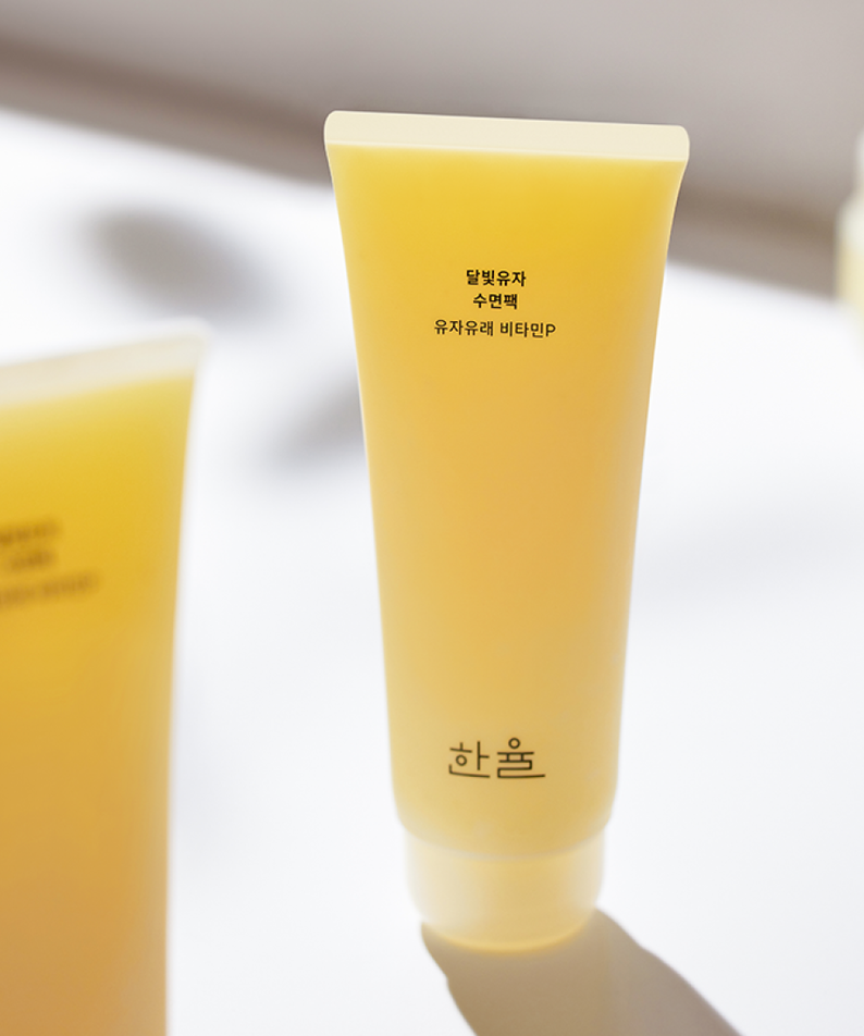 HANYUL Moonlight Yuja Sleeping Pack 100ml in bright yellow packaging against a soft background, showcasing the product.