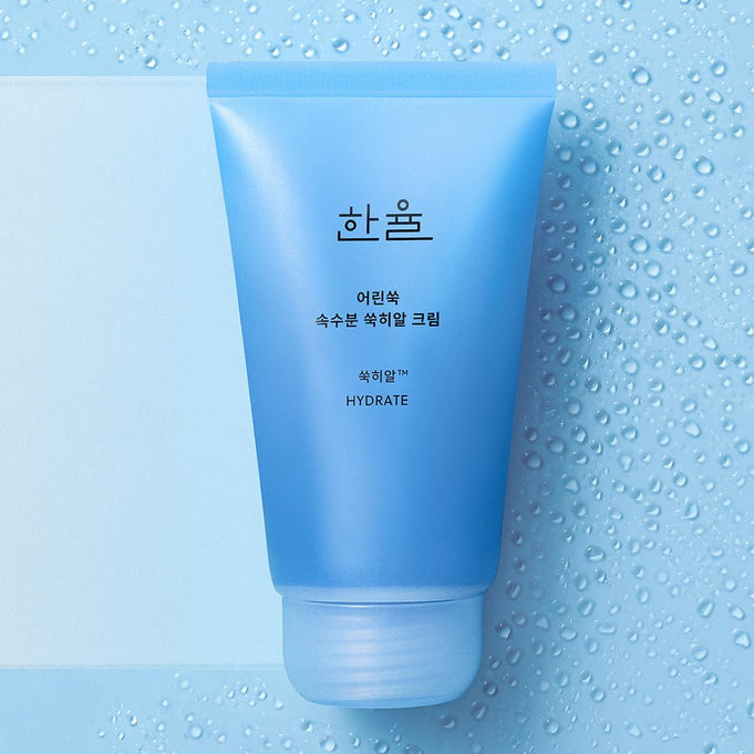 HANYUL Young Artemisia Extract Moisturizing Cream 60ml blue tube on wet surface background