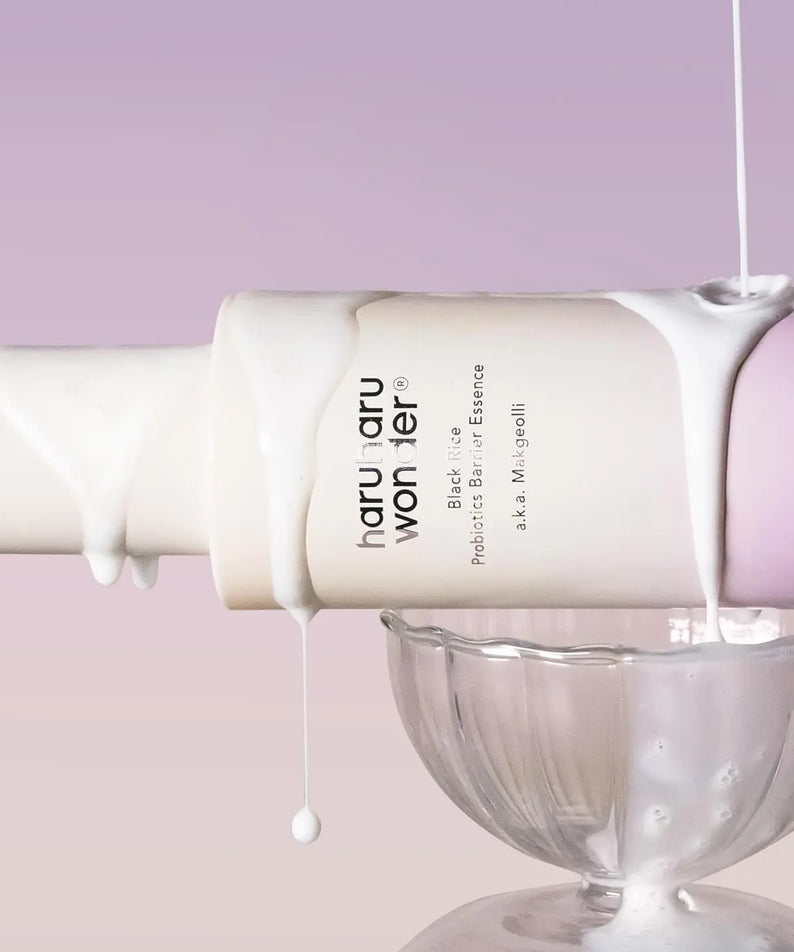 HARUHARU Black Rice Probiotics Barrier Essence 120ml bottle on display with white essence dripping into a glass bowl