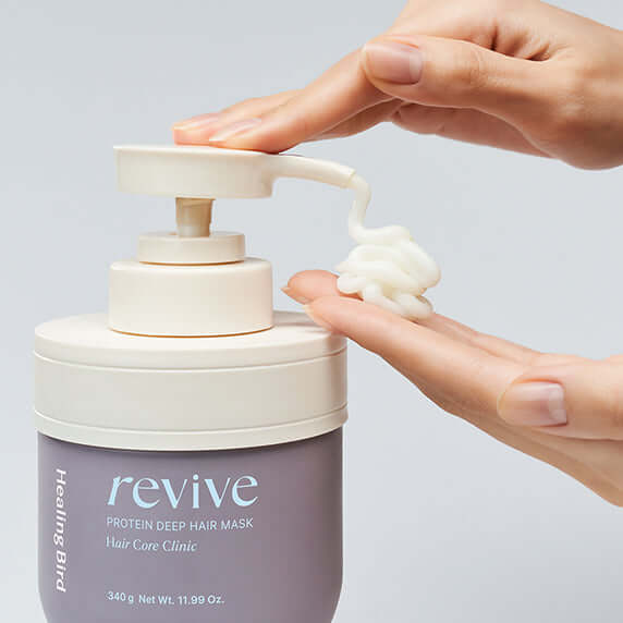 Hands dispensing HEALING BIRD Revive Protein Deep Hair Mask 340g from pump bottle.