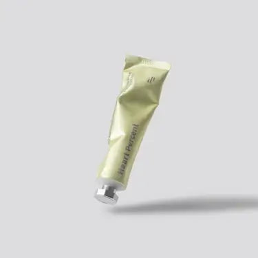 HEART PERCENT Commas On Life Brightrning Cleansing Balm tube on grey background