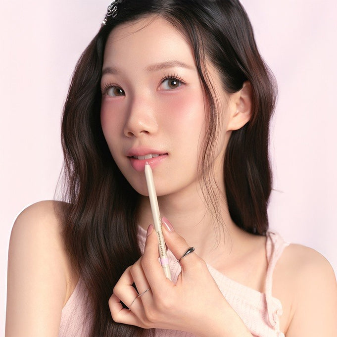 HEART PERCENT Dot On Mood Gel Eyeliner Pencil in use with model showcasing product against a soft pink background.