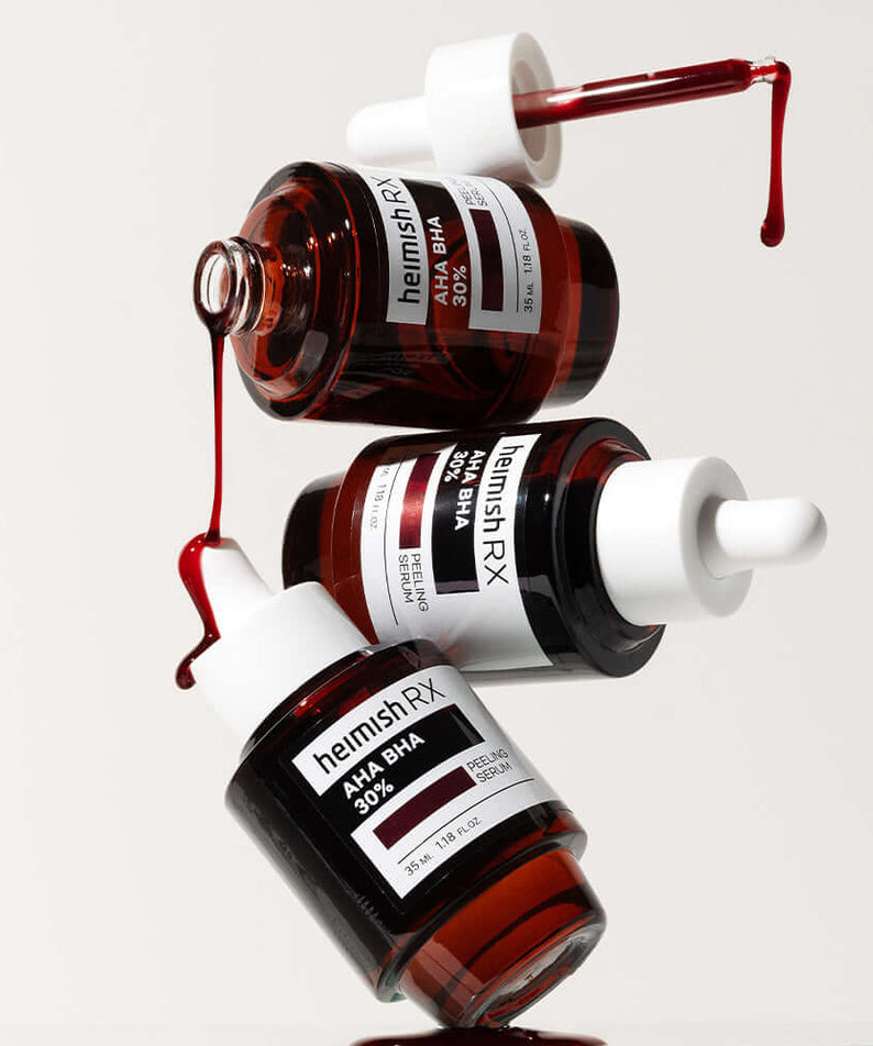 Three bottles of HEIMISH RX AHA BHA Peeling Serum 35ml with droppers, highlighting serum texture and packaging design.