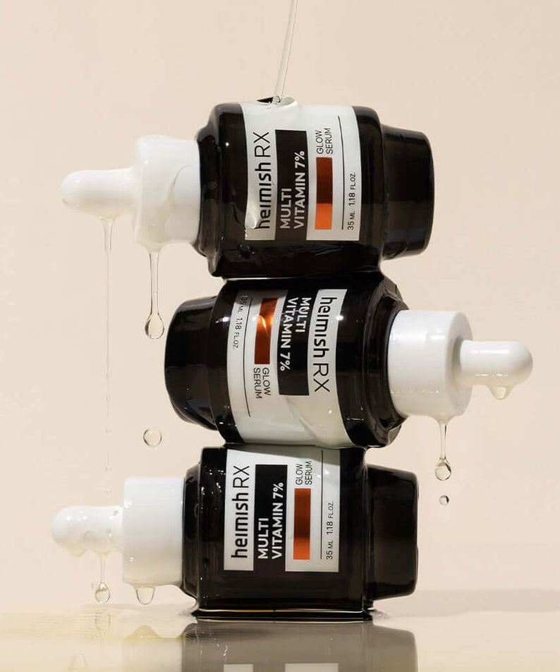 Stacked bottles of HEIMISH RX Multi Vitamin Glow Serum 35ml, showcasing its vibrant formula and sleek packaging design.