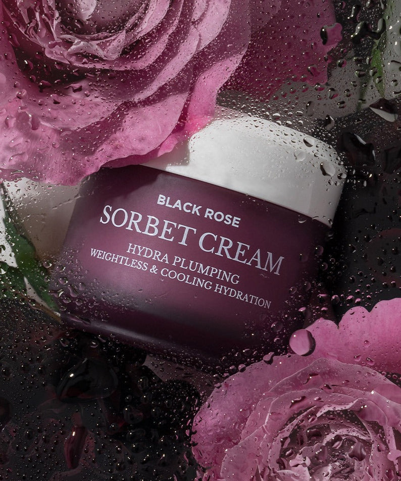 HEIMISH Black Rose Hydra Plumping Shavet Cream 50ml in a visually striking setting with vibrant pink roses and water droplets.