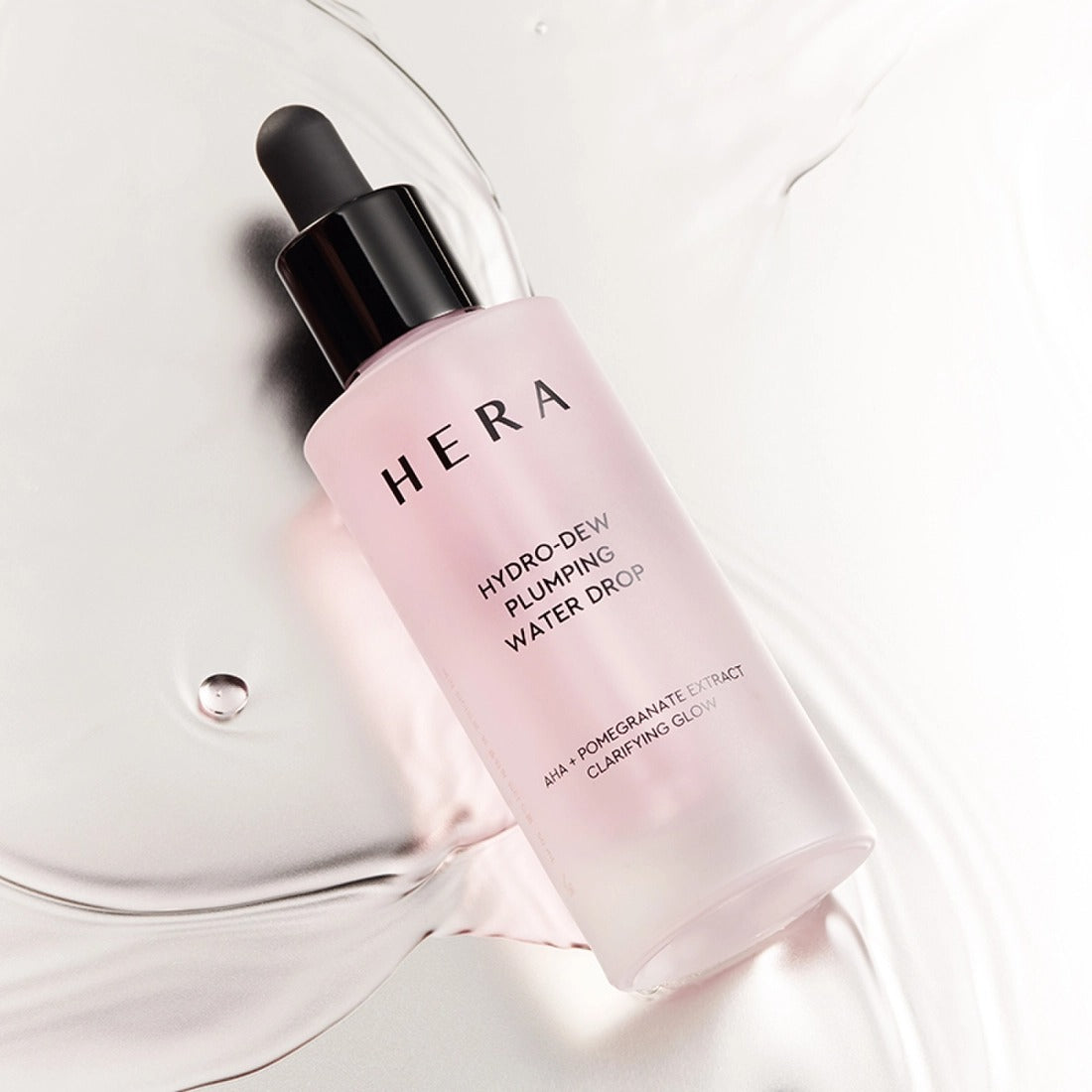 HERA Hydro-Dew Pluming Water Drop 50ml bottle on a light background highlighting its skincare benefits.