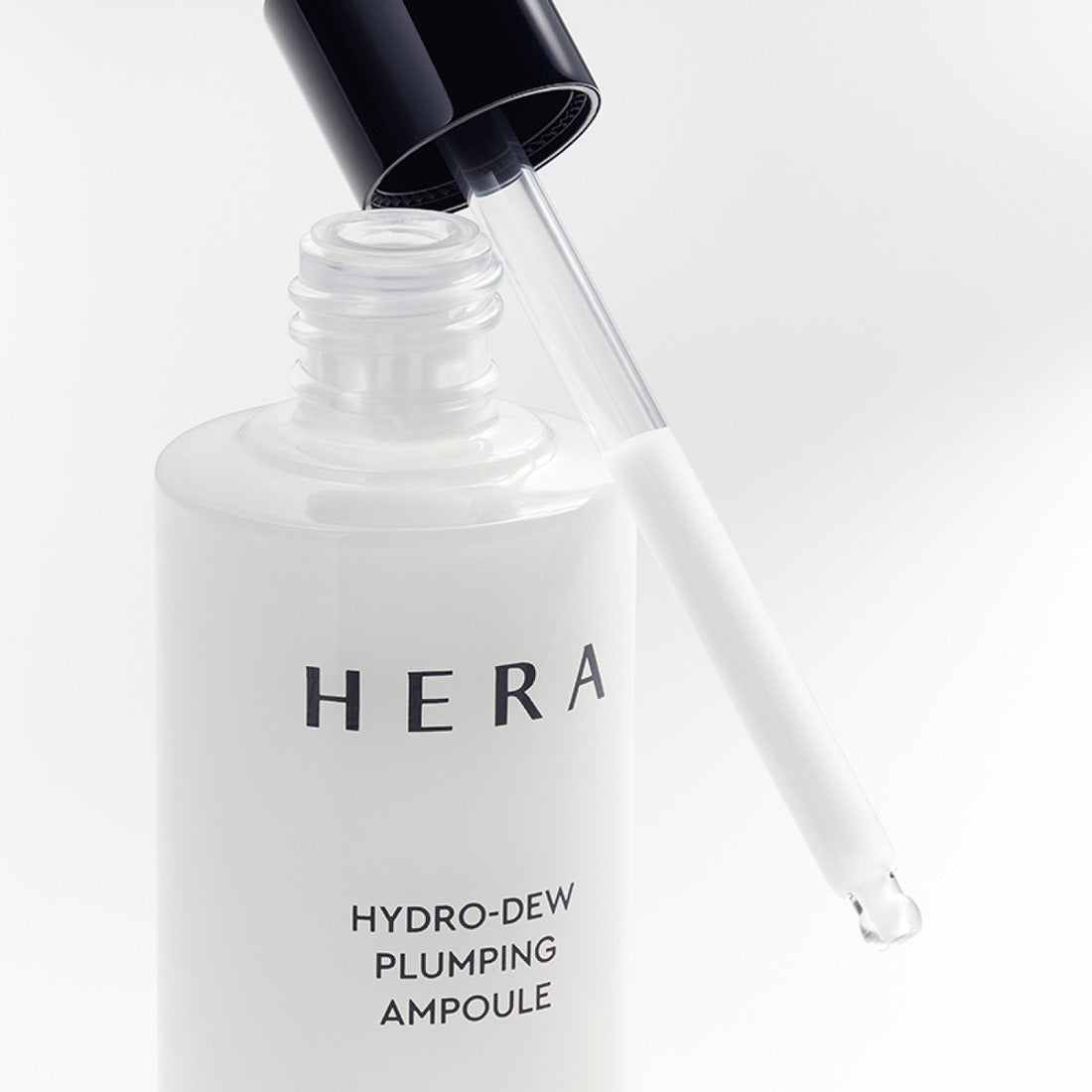 HERA Hydro-Dew Plumping Ampoule 50ml with dropper, luxury skincare product for hydration and plumping.