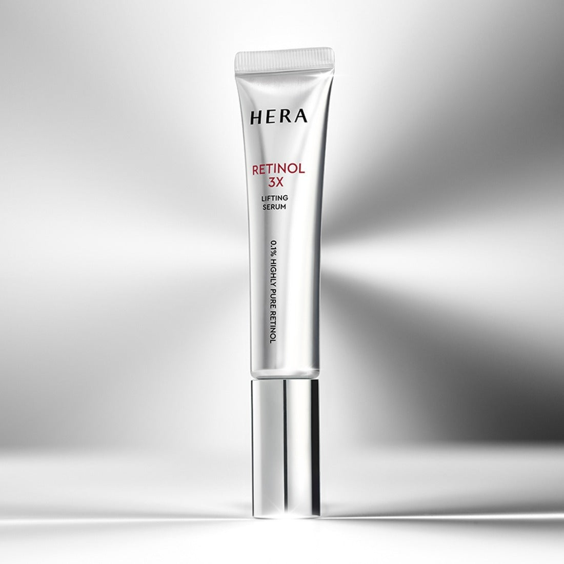 HERA Retinol 3X Lifting Serum 25ml in sleek packaging on a reflective surface