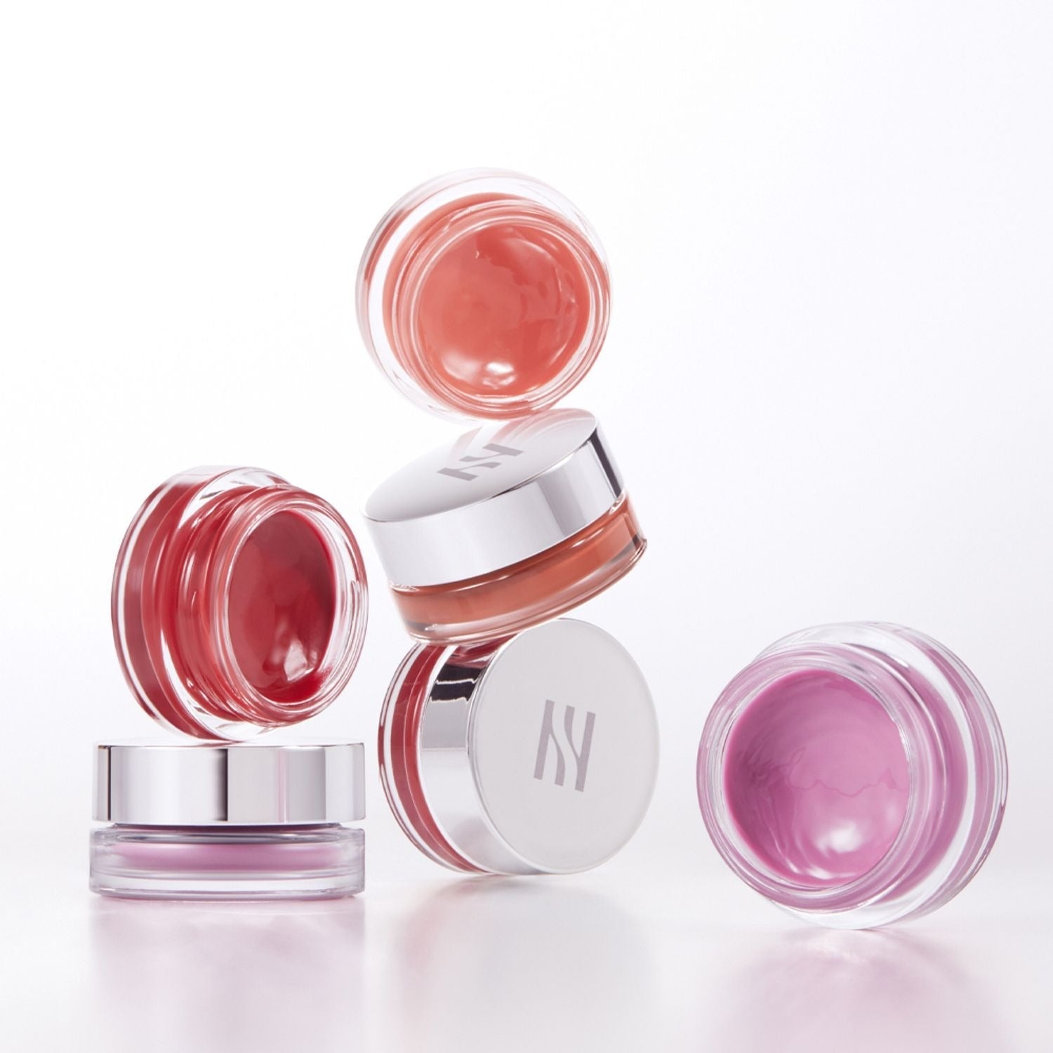 Assorted shades of HERA Sensual Lip & Cheek 7g in clear jars with silver lids.