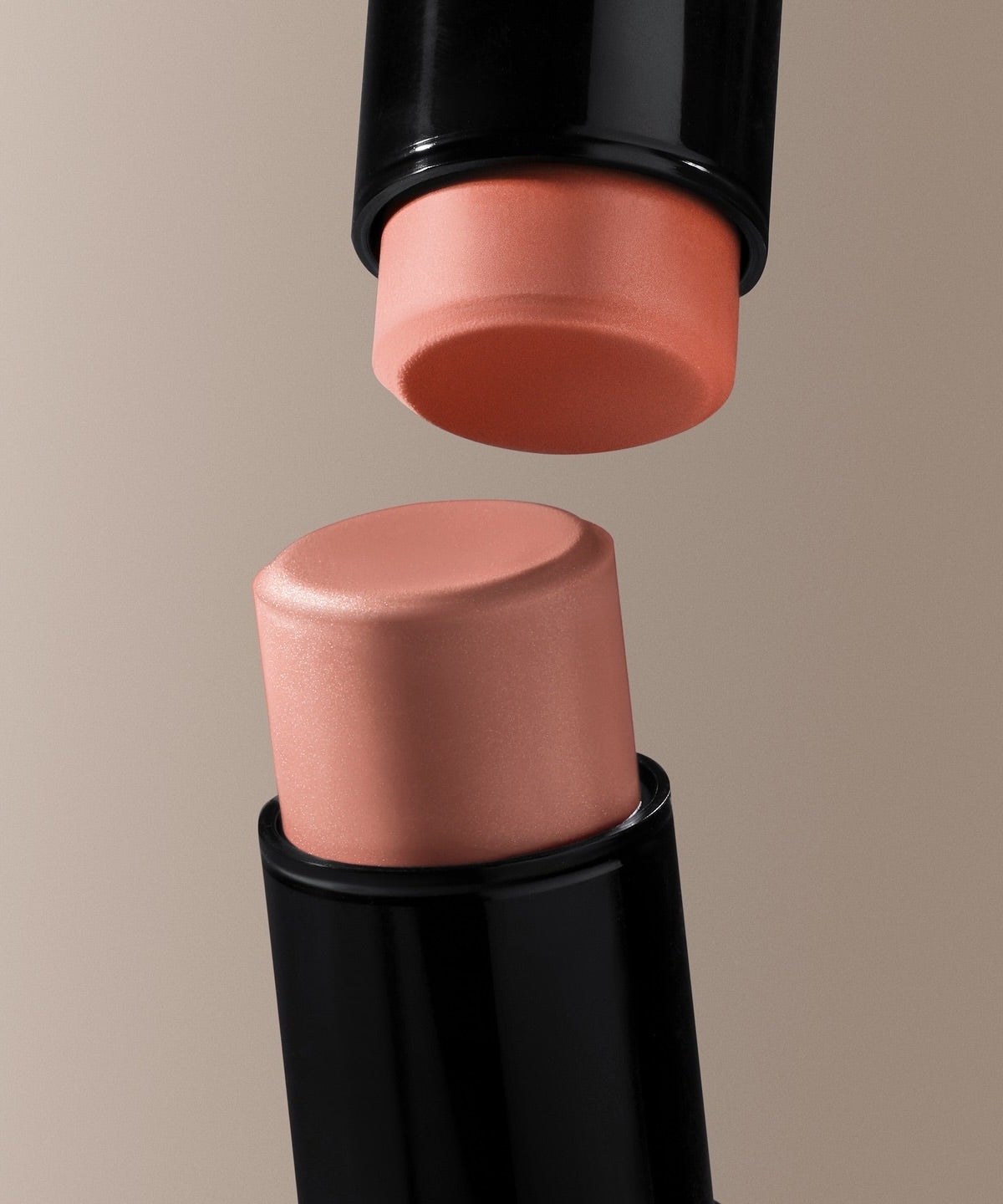 HERA Blush Stick 7.7g in coral and peach shades, perfect for a natural glow, close-up shot