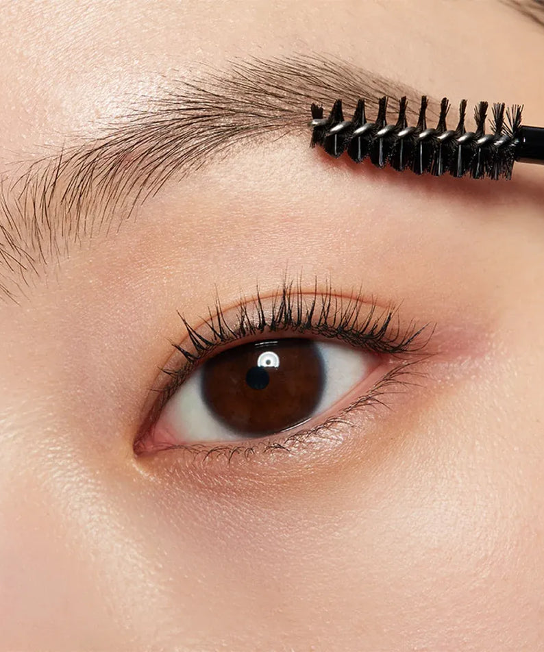 Close-up of eyebrow being brushed with HERA Brow Desighner Auto Pencil for perfect brow styling.