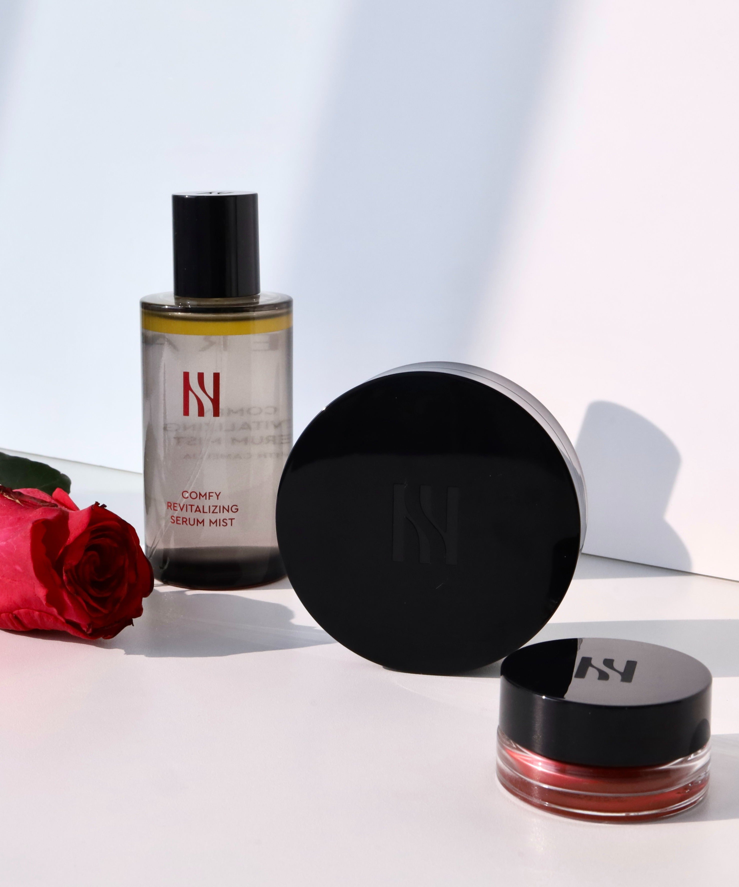 HERA Comfy Revitalizing Serum Mist 90ml with red rose in background