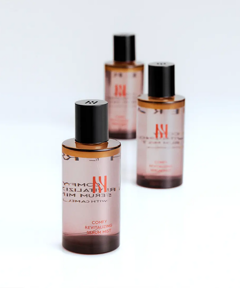 Three bottles of HERA Comfy Revitalizing Serum Mist 90ml on a white background.