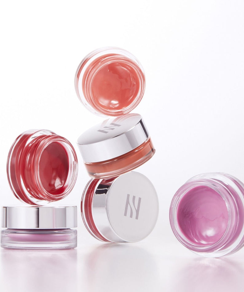 Assorted shades of HERA Sensual Lip & Cheek 7g in clear jars with silver lids.