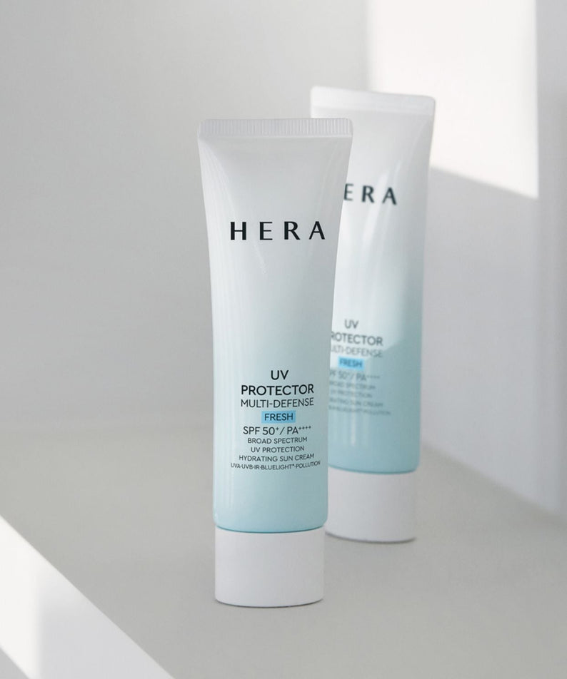 HERA UV Protector Multi-Defense Fresh SPF50+PA++++ 50ml on a white surface, offering superior sun protection and freshness.