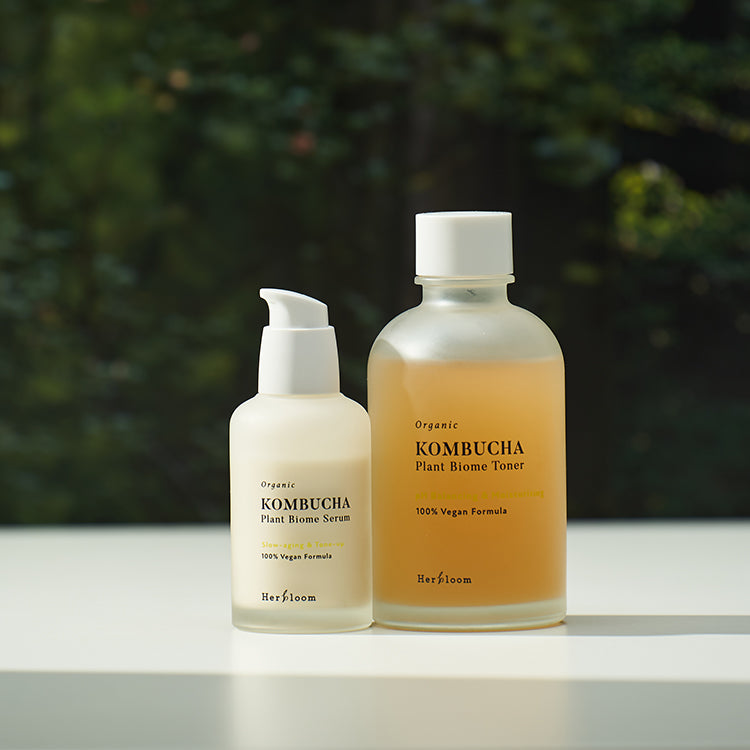 HERBLOOM Vegan Starter Set (Serum + Toner) displayed on a table with bottles of organic vegan skincare products.