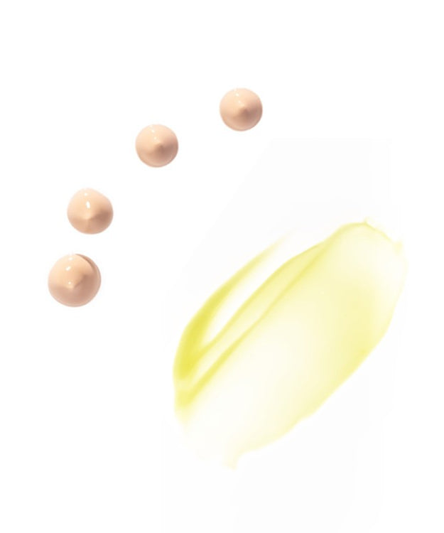 Texture of HERBLOOM Bakuchiol Dual Vita Eye Cream showing beige cream drops and yellow oil smear on white background.