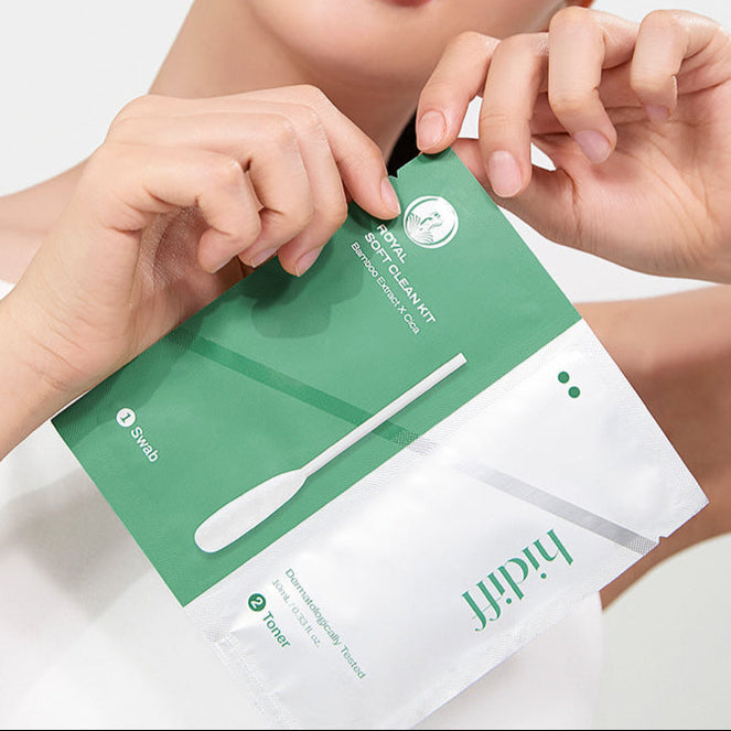 Person holding HIDIFF Royal Soft Clean Kit package in hands. Green minimalistic packaging with cleaning swab.