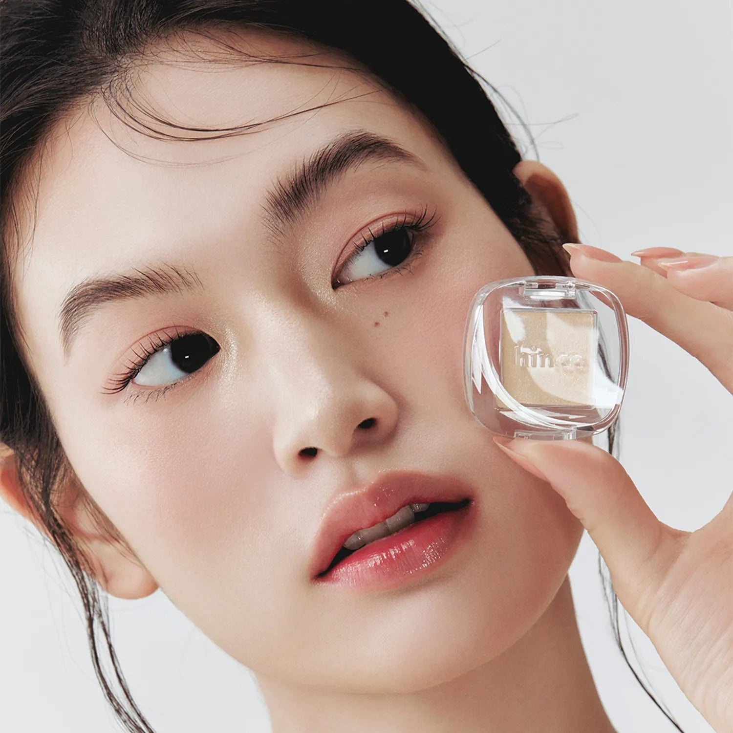 Close-up of woman showcasing HINCE Single Eyeshadow, highlighting eye makeup with a focus on natural beauty and elegance.