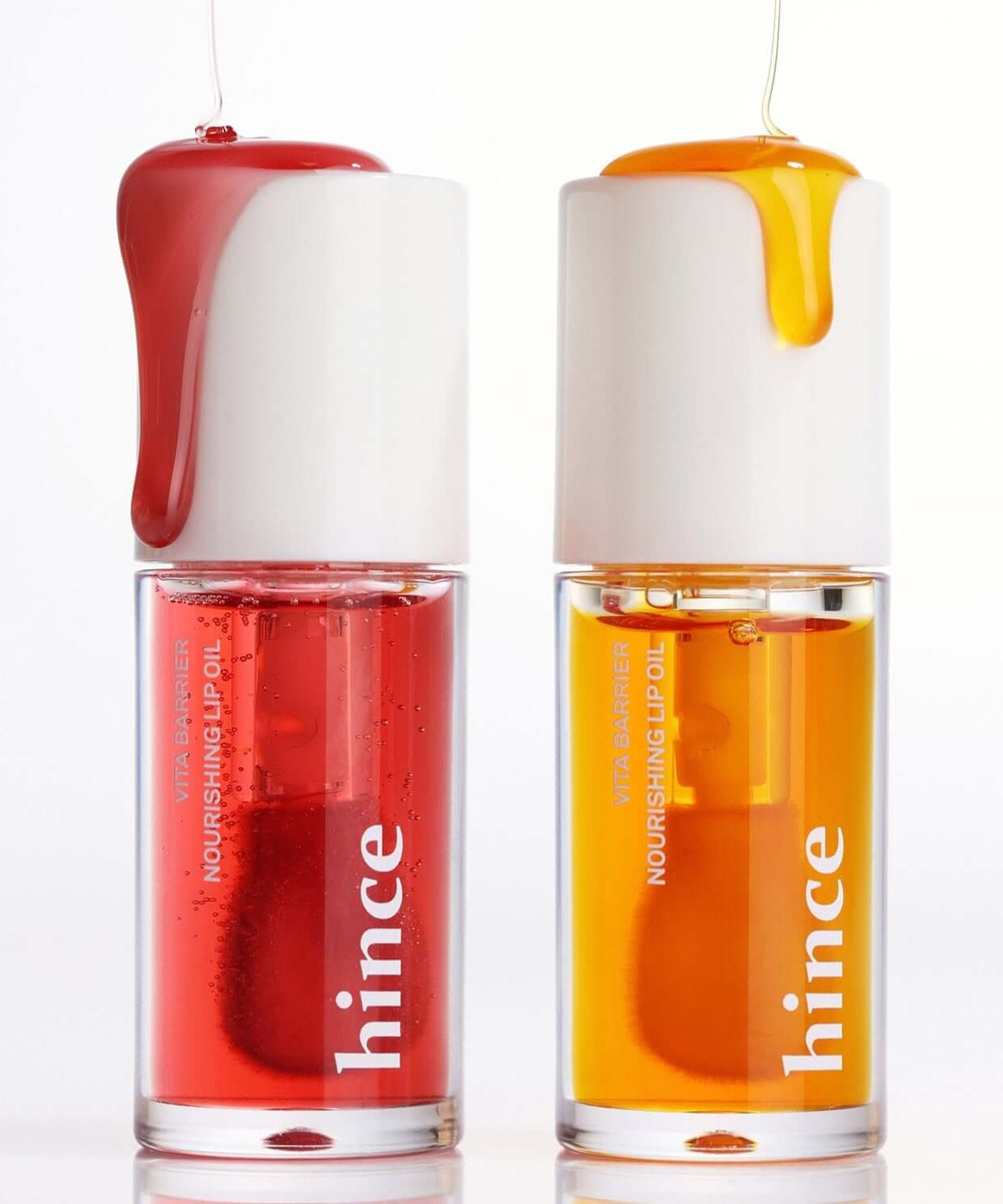 HINCE Vita Barrier Nourishing Lip Oil in red and orange, showing two bottles with oil dripping from the top.