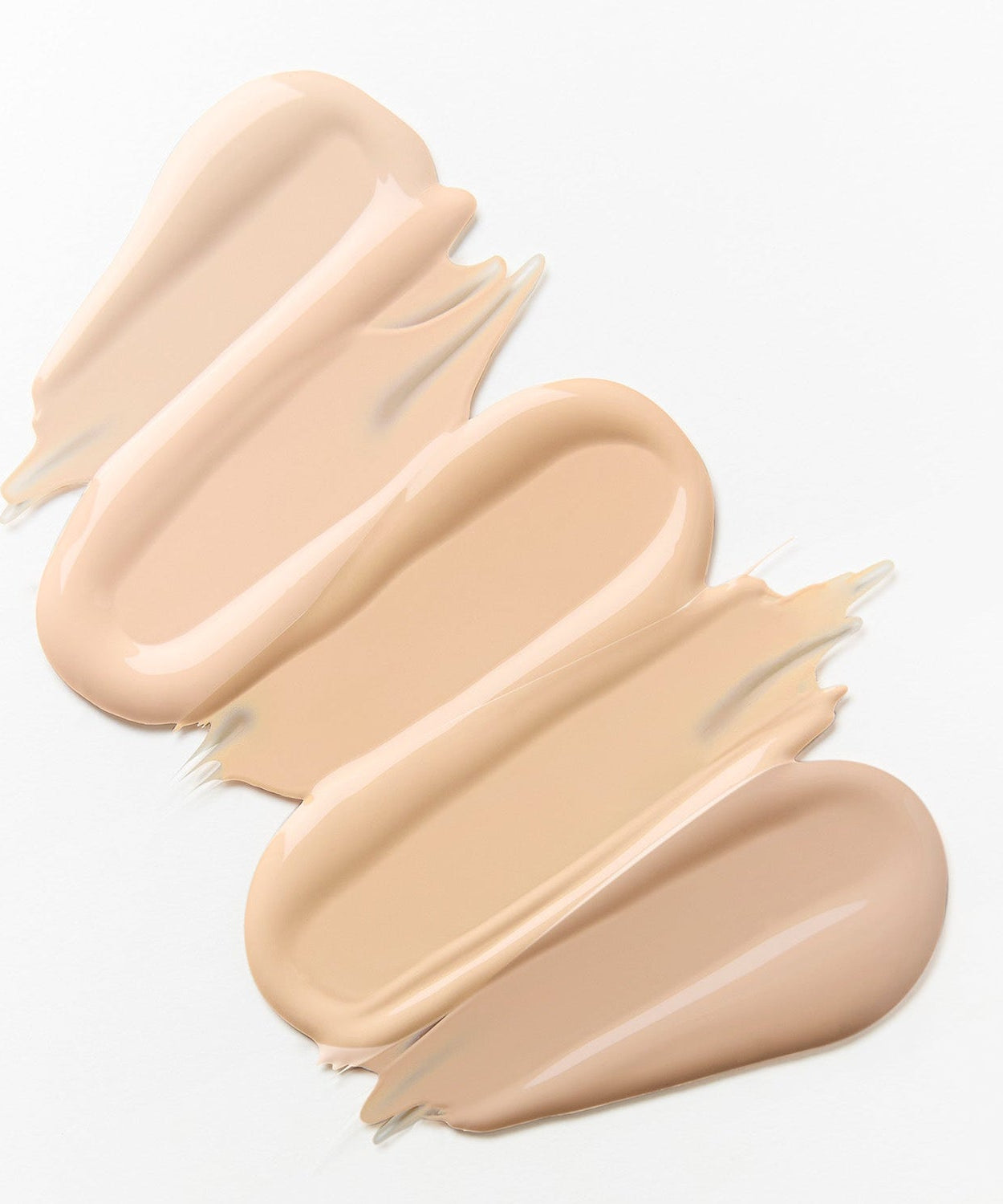 Texture of HINCE Cover Master Pink Cushion foundation in various shades on a white background.