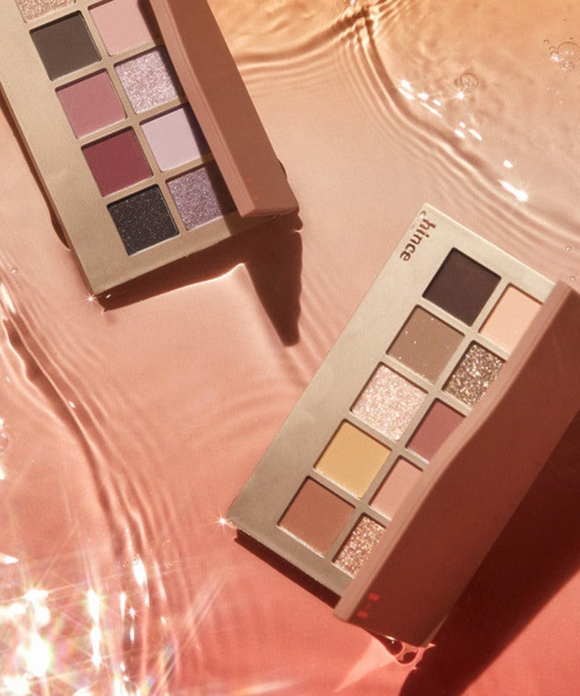 HINCE New Depht Eye Shadow Palette with shimmering shades on a reflective surface