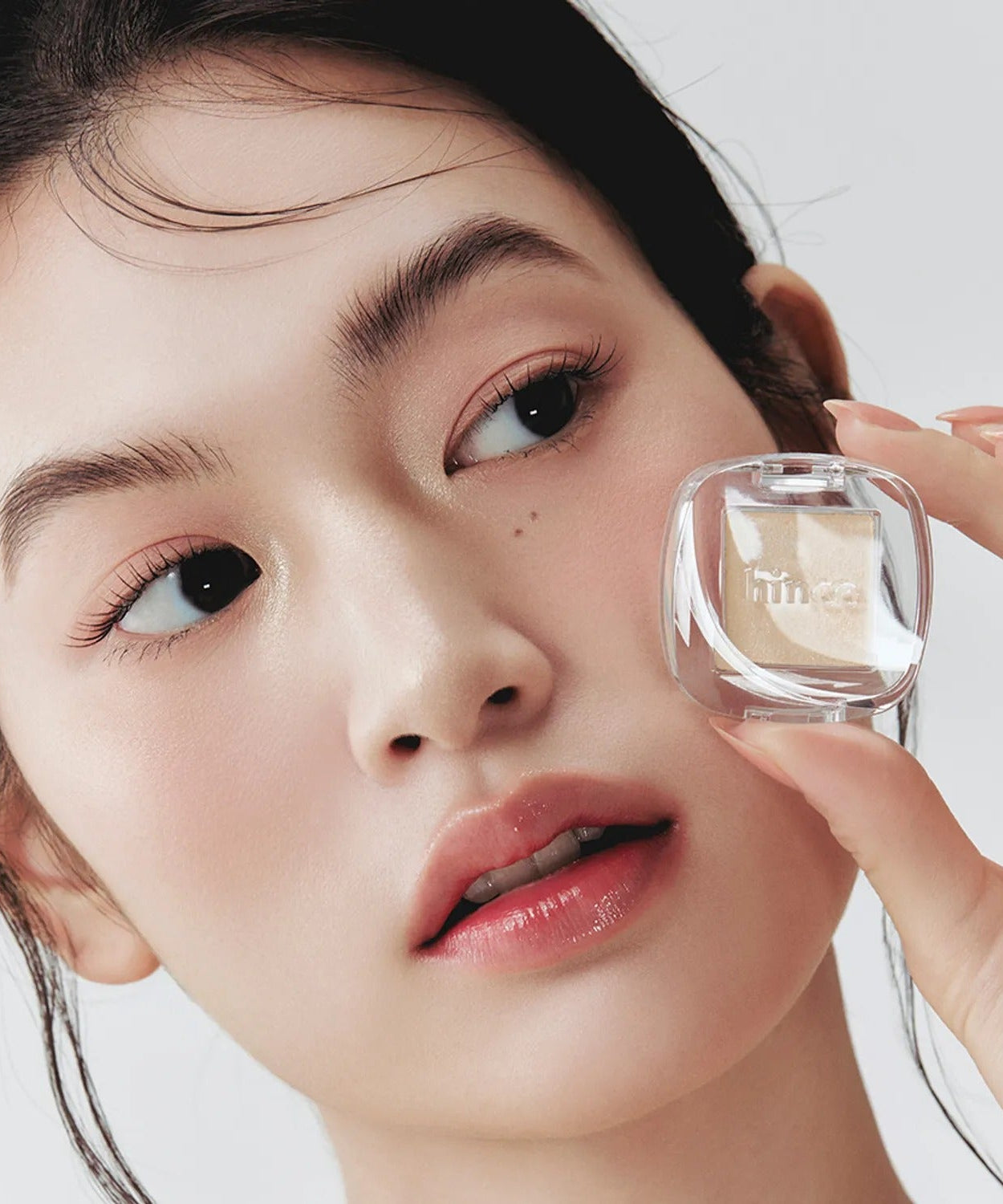 Close-up of woman showcasing HINCE Single Eyeshadow, highlighting eye makeup with a focus on natural beauty and elegance.