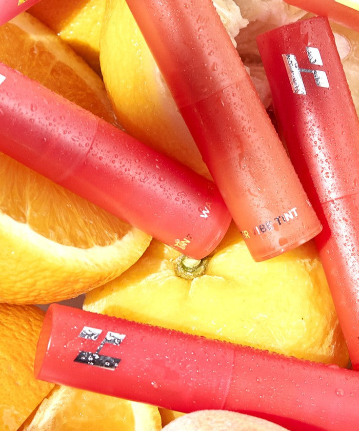 HOLIKA HOLIKA Water Vibe Tint lip products displayed on fresh citrus slices