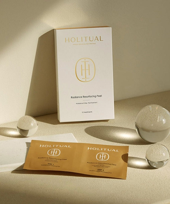 HOLITUAL Radiance Resurfacing Peel package with product and materials displayed elegantly on a beige background.