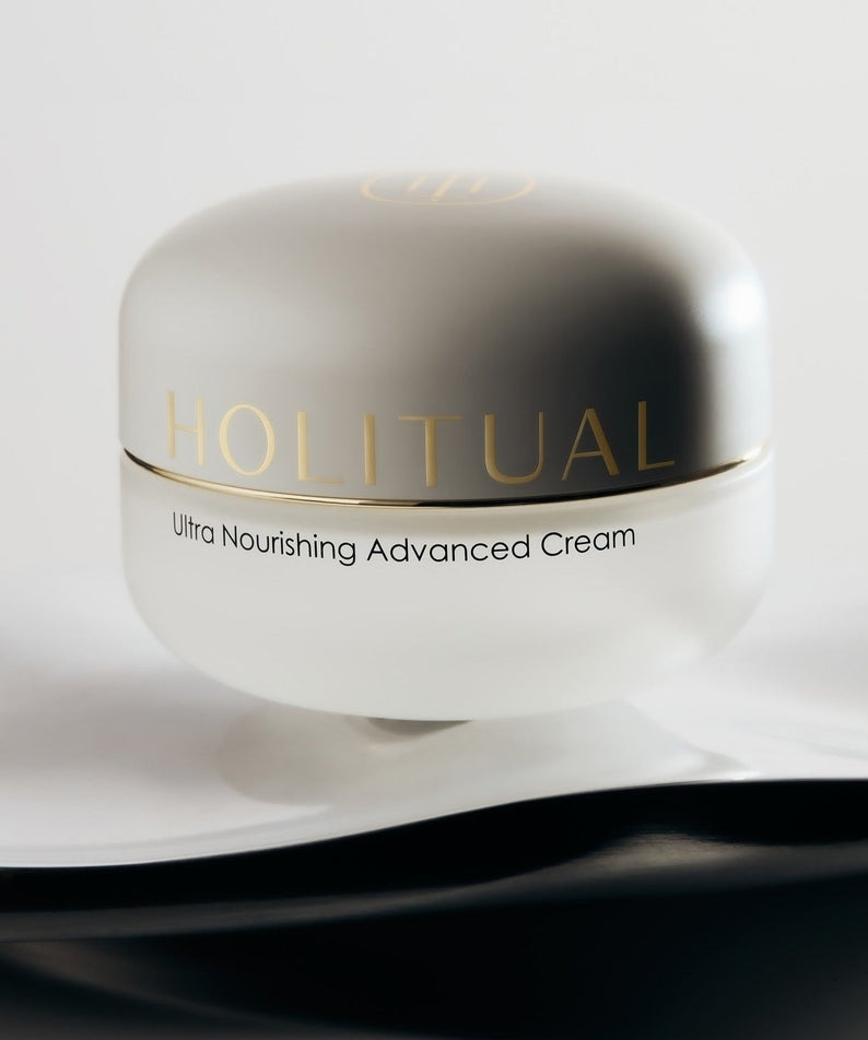 HOLITUAL Ultra Nourishing Advanced Cream in an elegant jar on a soft fabric background