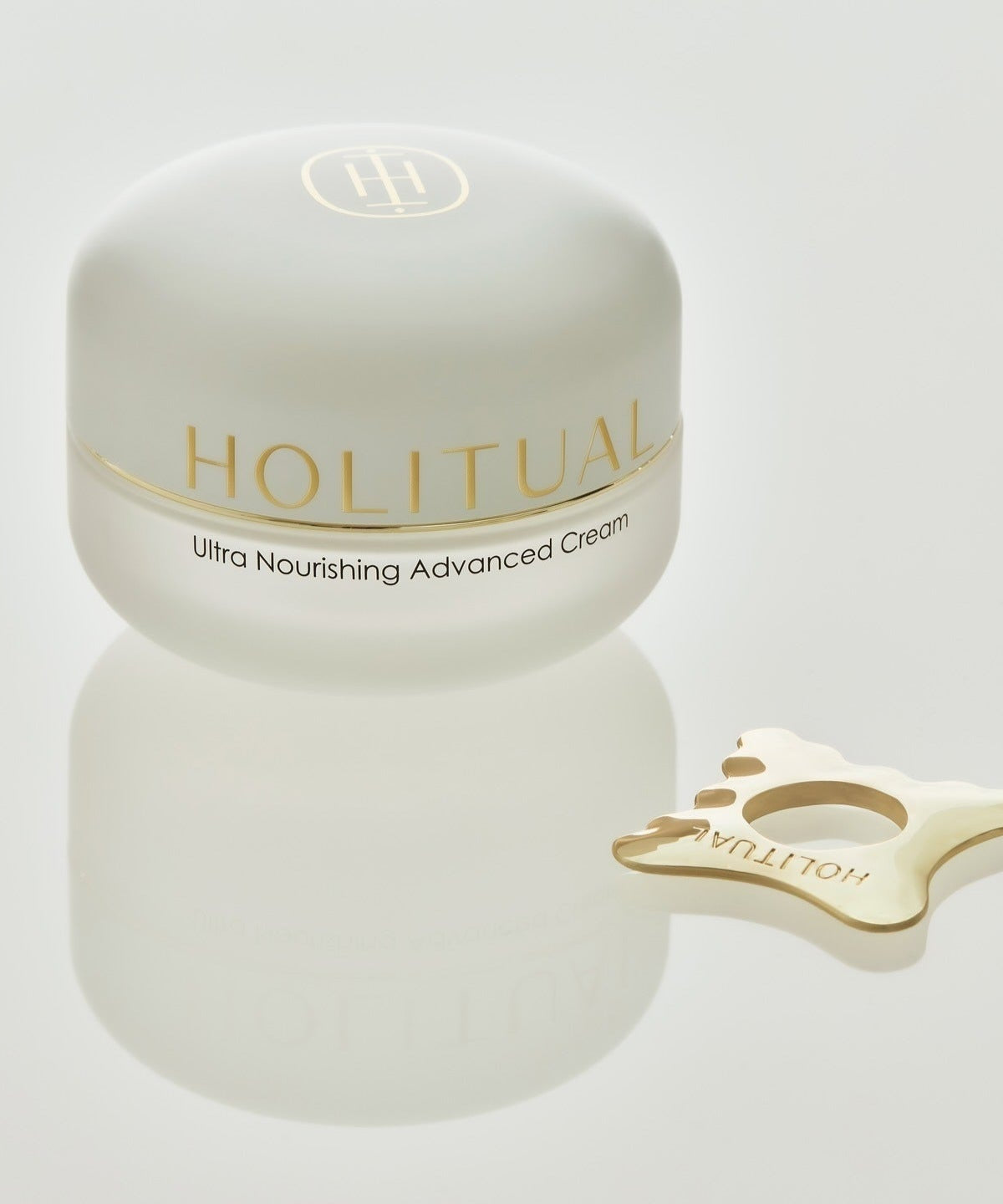 HOLITUAL Ultra Nourishing Advanced Cream with gold accessory on white background