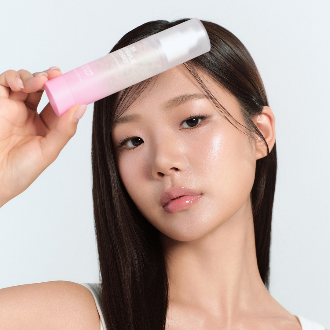 Model holding HOUSE OF HUR 3X Capsule Hydro Booster Cream 50ml, showcasing glowing skin and beauty benefits.
