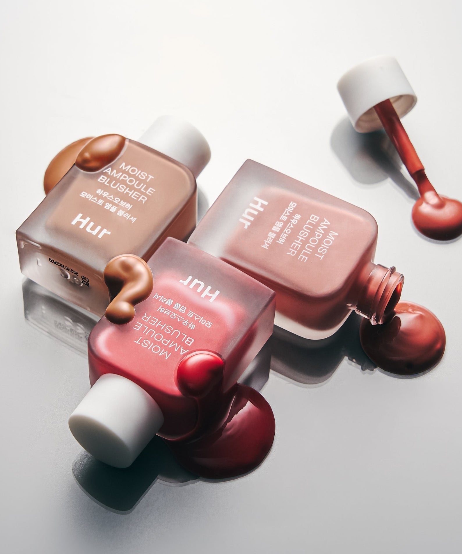 HOUSE OF HUR Moist Ampoule Blusher 10ml bottles with creamy texture on a reflective surface