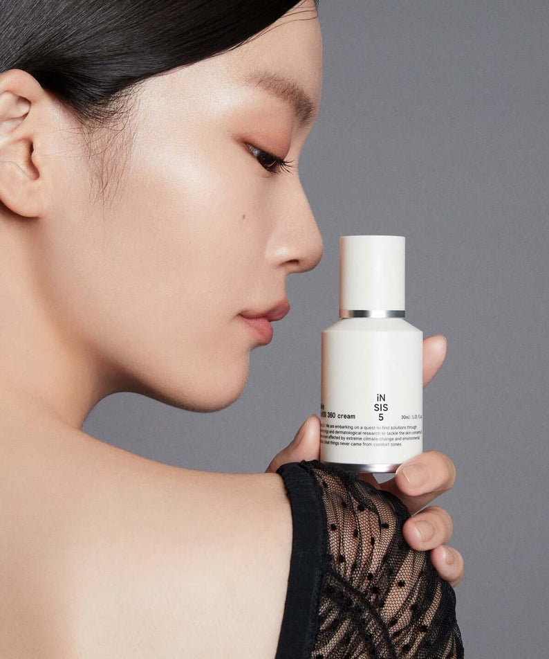 HUXLEY Biosys 360 Cream held by a woman showcasing skincare product