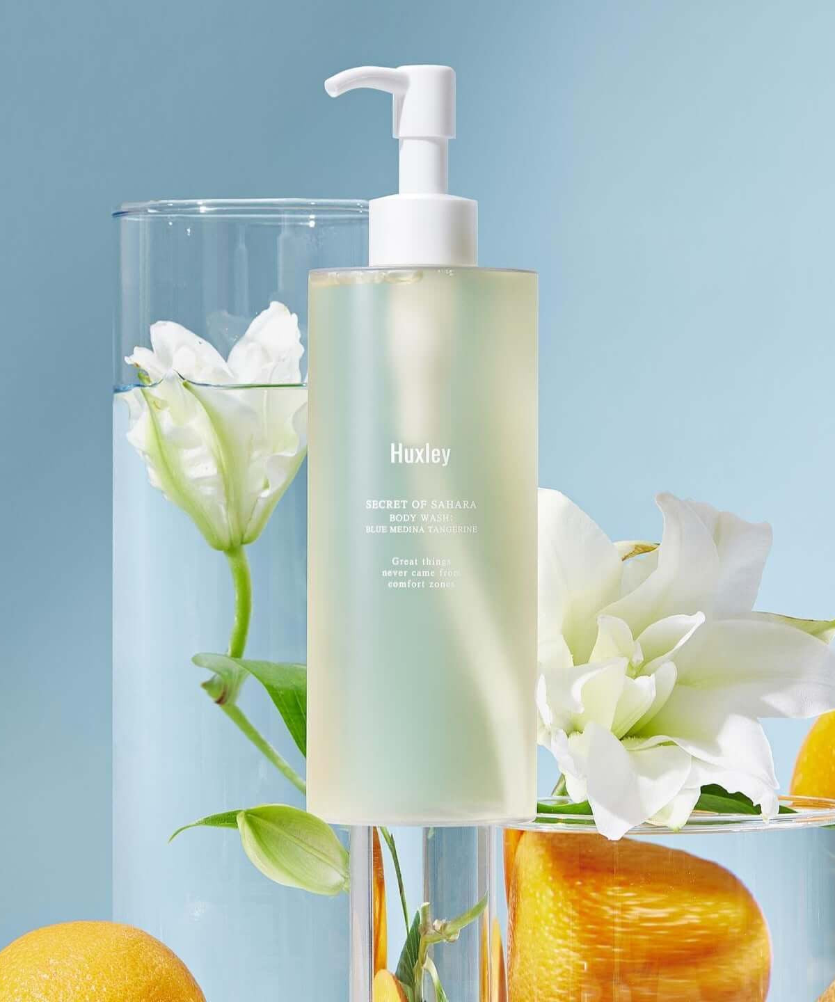 HUXLEY Body Wash Blue Medina Tangerine with citrus and floral backdrop