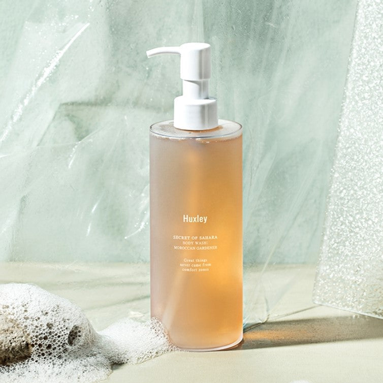 HUXLEY Bodywash Moroccan Gardener 300ml product image with pump dispenser, surrounded by bubbles and natural elements