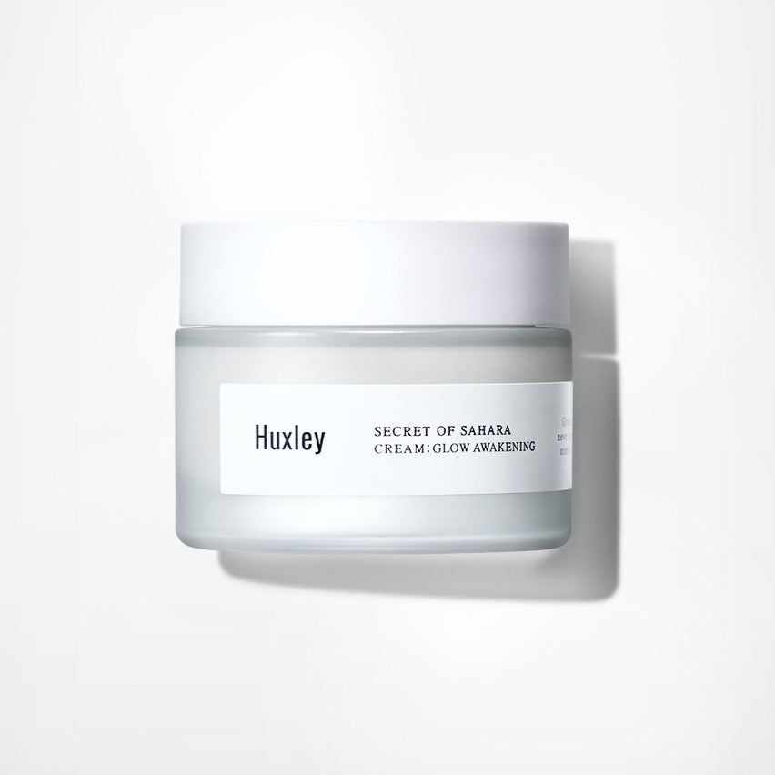 HUXLEY Cream Glow Awakening 50ml in a frosted jar with white lid, offering skin moisturizing and brightening benefits for a radiant glow.