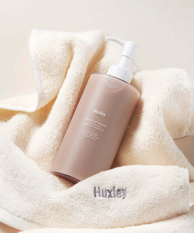 HUXLEY Hand Wash Moroccan Gardener bottle on a soft towel, showcasing luxurious hand cleansing solution with a touch of elegance