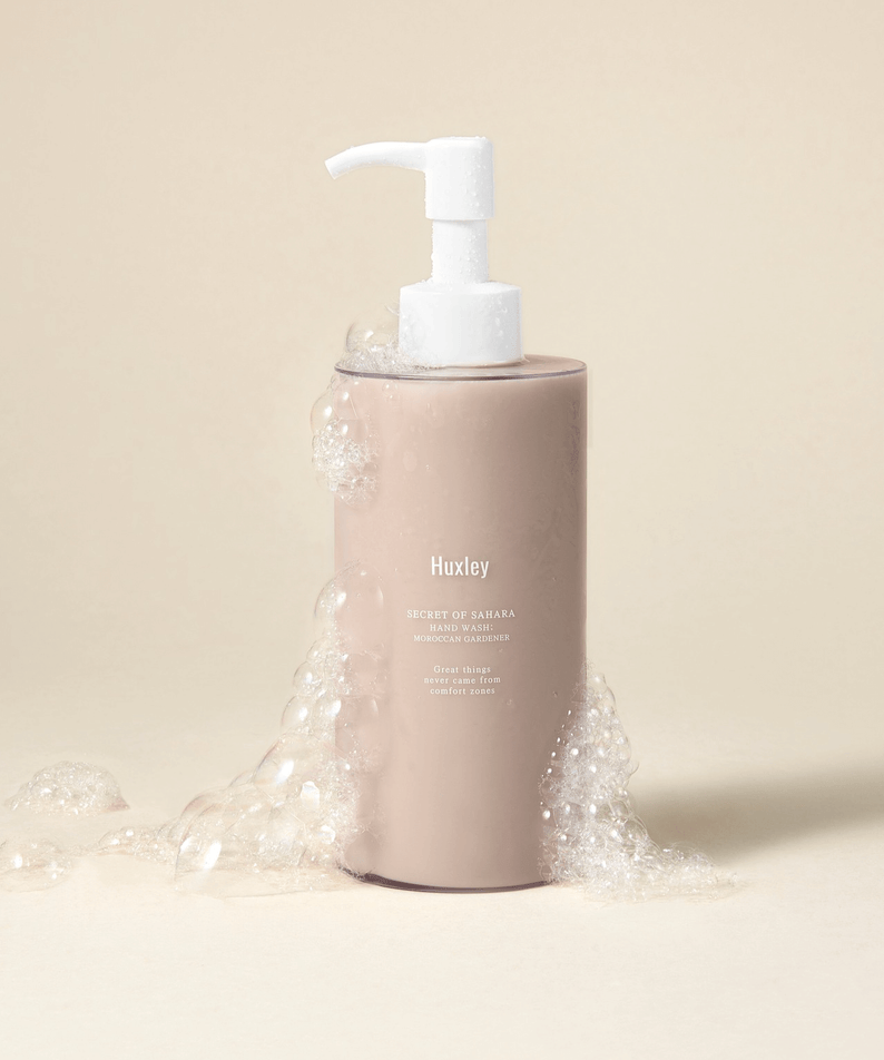 HUXLEY Hand Wash Moroccan Gardener bottle with bubbles on a neutral background.