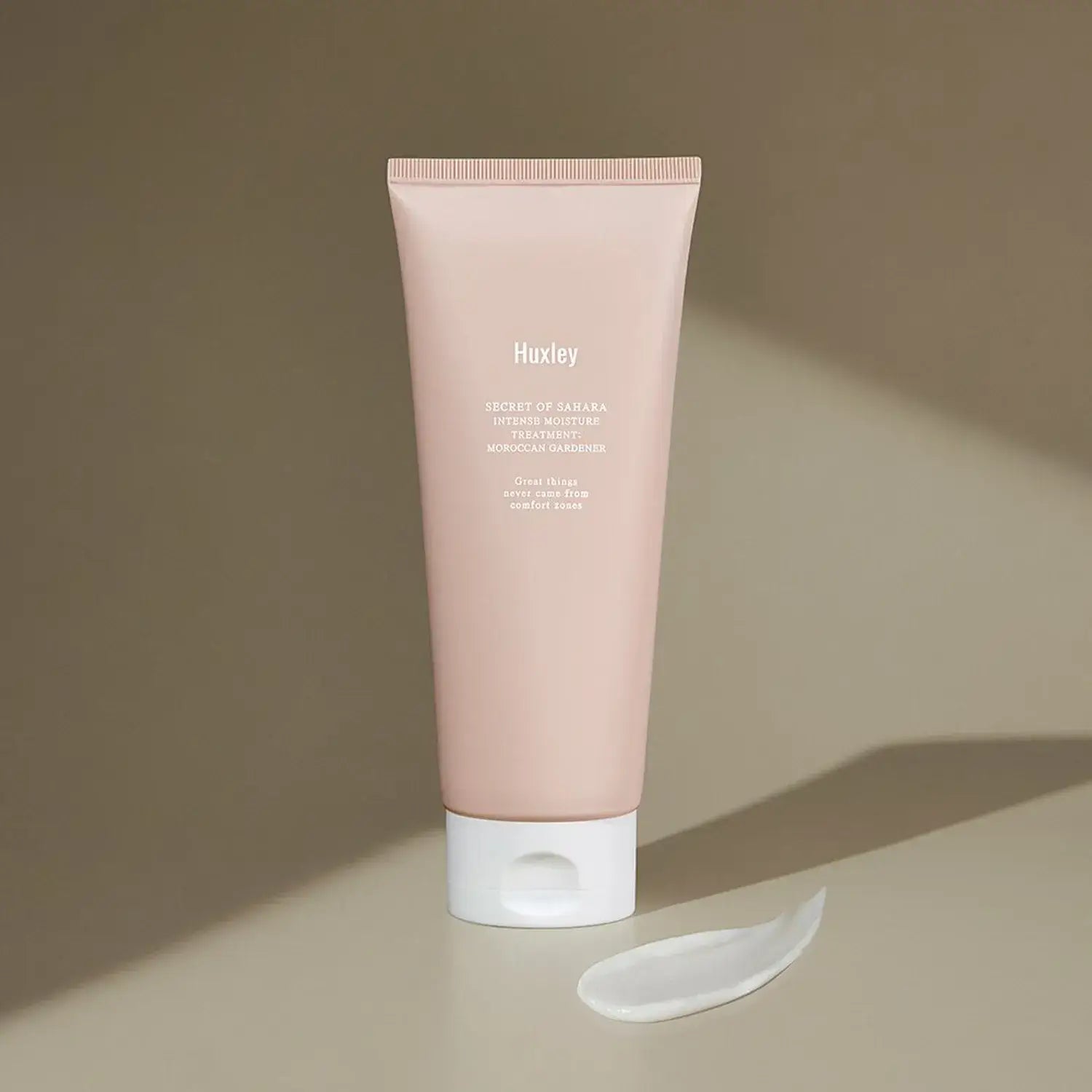 HUXLEY Intense Moisture Treatment Moroccan Gardener tube with cream swatch on brown background