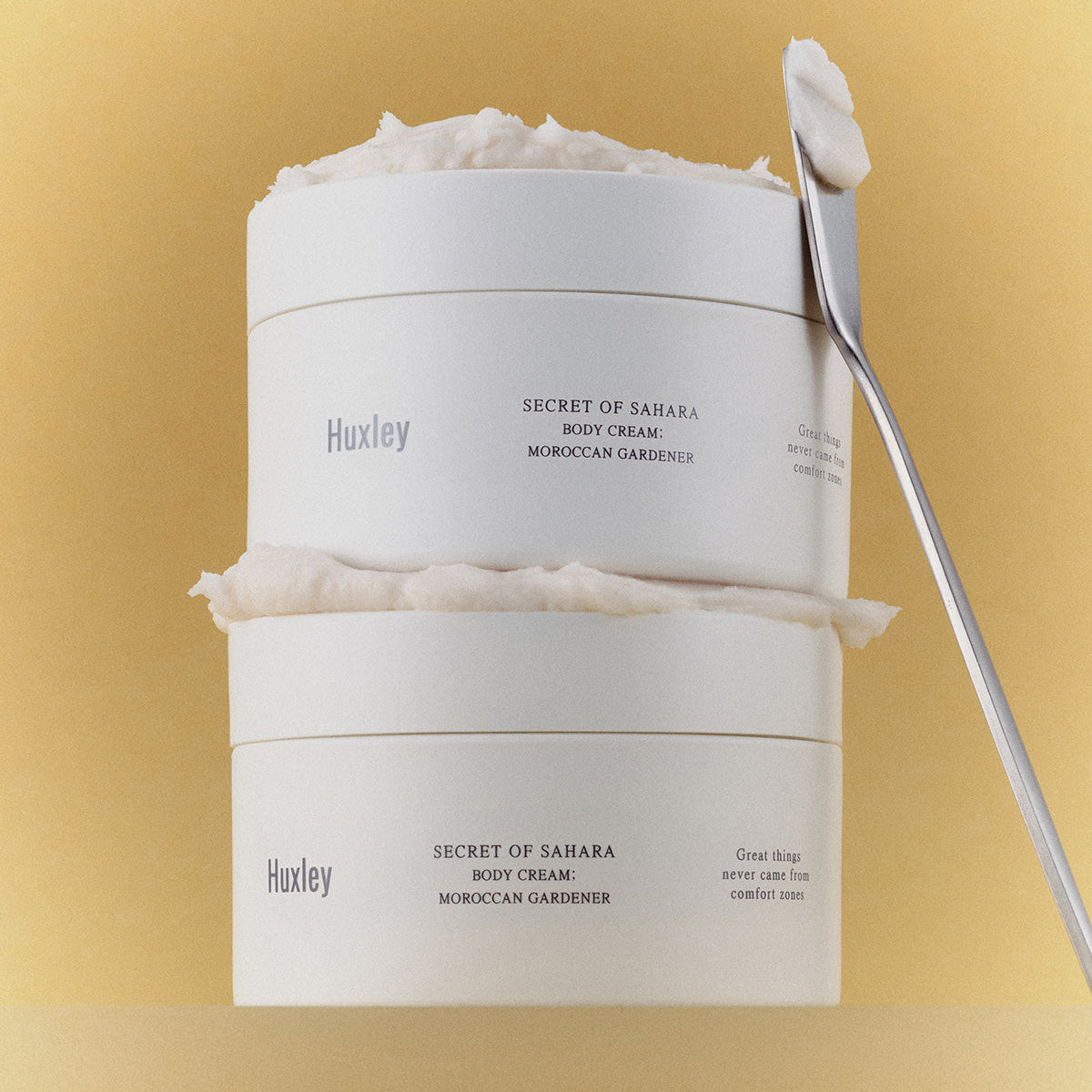 HUXLEY Moroccan Gardener Body Cream 200ml stacked jars with spatula on a beige background