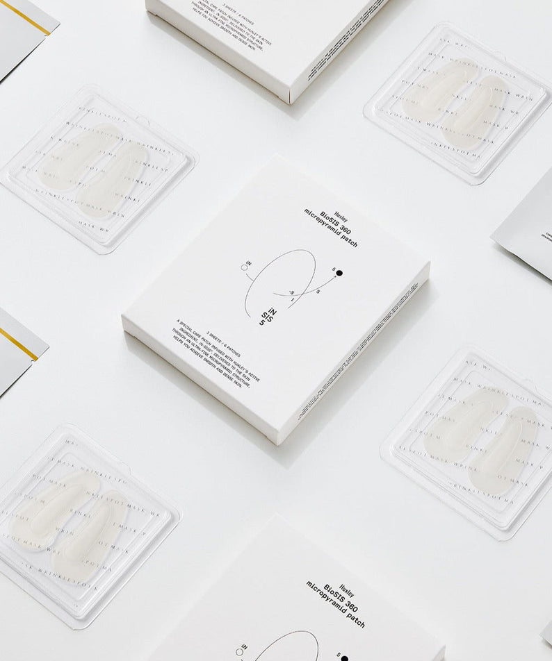 Display of HUXLEY BioSIS 360 Micropyramid Patch packaging and patches on a white background.