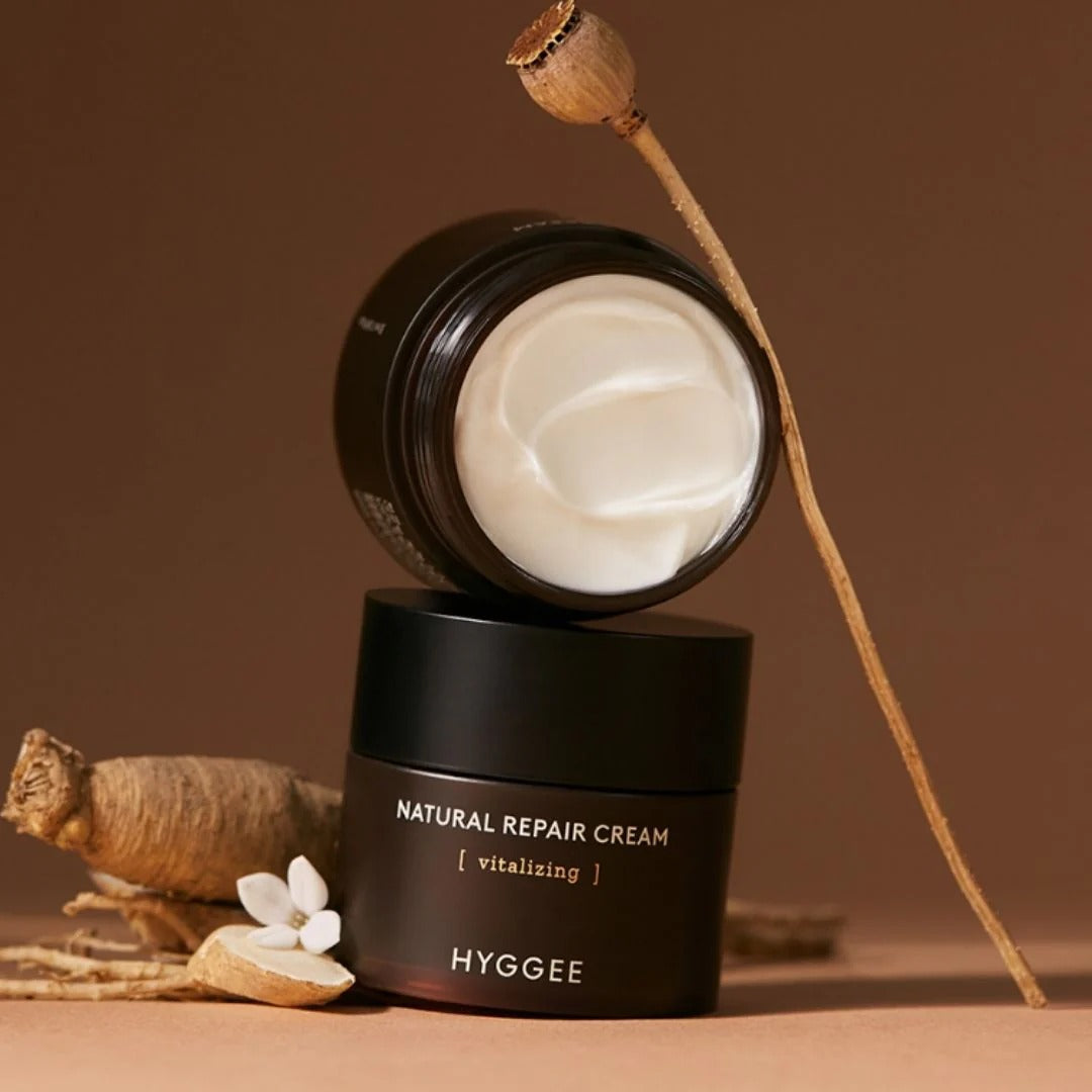 HYGGEE Nature Repair Cream 50ml in an elegant brown container with herbal elements, showcasing the cream's smooth texture and natural ingredients