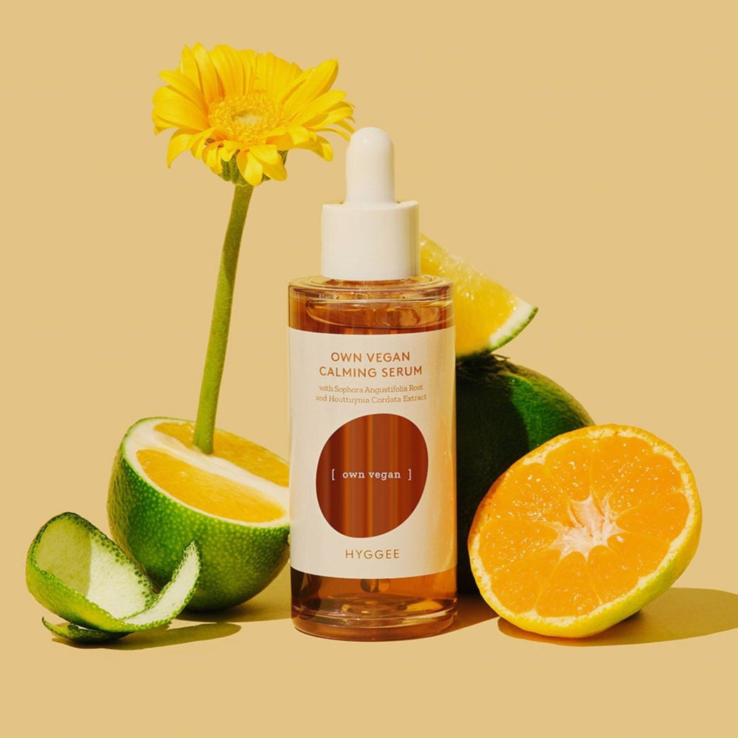 HYGGEE Own Vegan Calming Serum 50ml with citrus fruits and flower backdrop