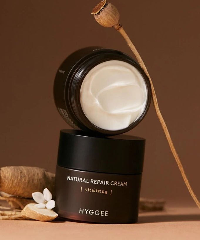 HYGGEE Nature Repair Cream 50ml in an elegant brown container with herbal elements, showcasing the cream's smooth texture and natural ingredients