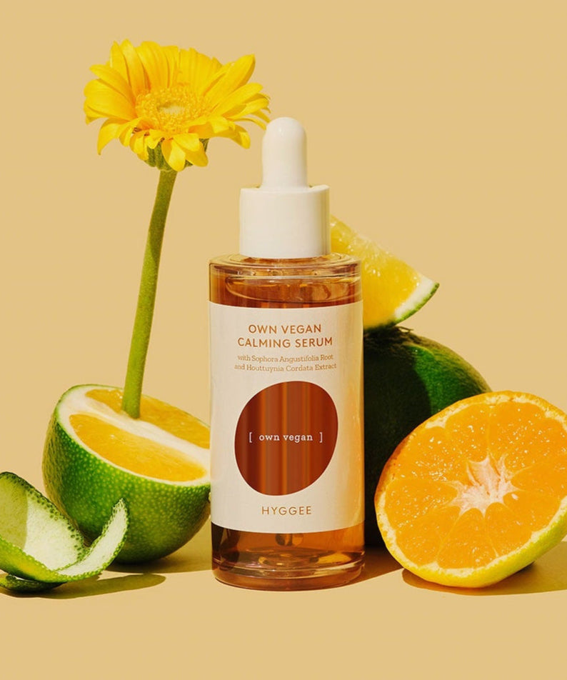 HYGGEE Own Vegan Calming Serum 50ml with citrus fruits and flower backdrop