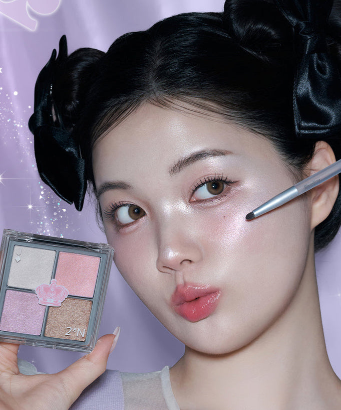 Model applying 2AN Jelly Glow Highlighter Palette 10.8g with makeup brush, showcasing shimmer effect on cheek.