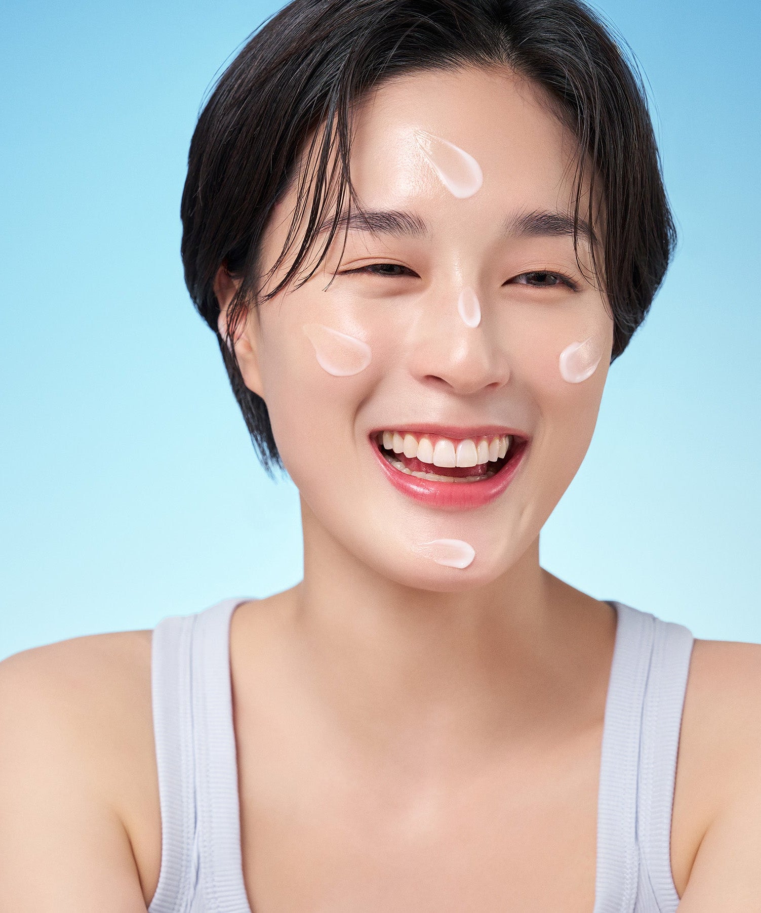 Smiling woman applying PURITO Hydro Wave Deep Sea Cream 50ml on face, showing hydrated skin.